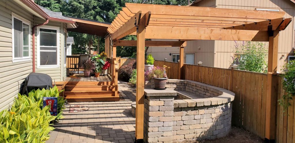 Beautiful stone and wood deck and patio exterior by Nikao Construction